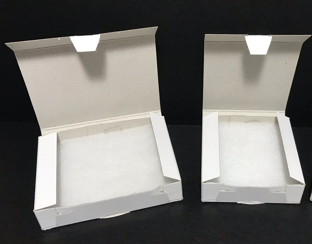 Boxes: Folding Jewelry Boxes. Gloss White Economy Jewelry Boxes with Cotton Pads.  Three Popular Sizes.  Packed 250 Boxes.  Cost: 17.5 Cents to 20.5 Cents Each.